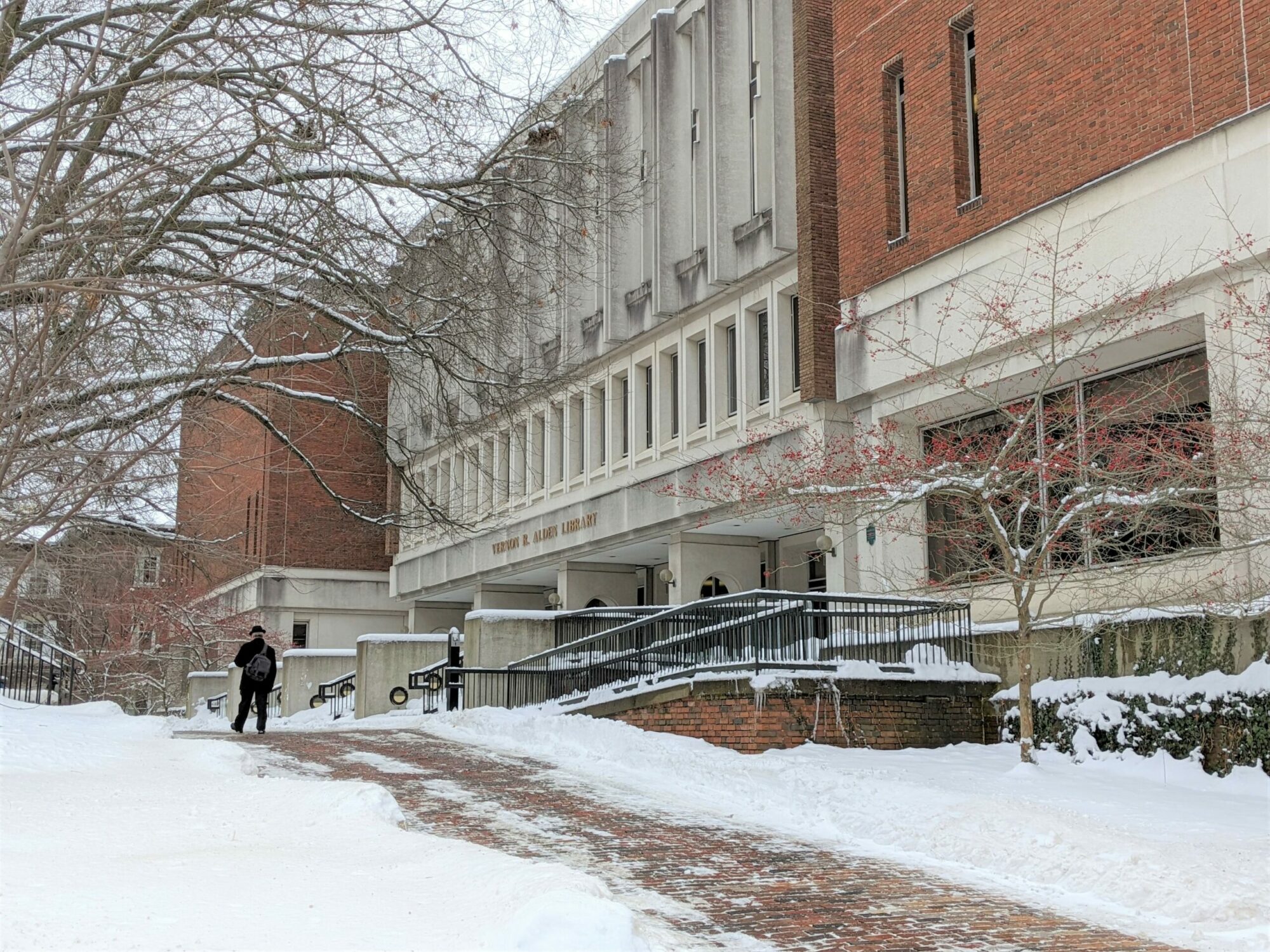 Exterior of the Vernon R. Alden Library with snow on the ground and one figure