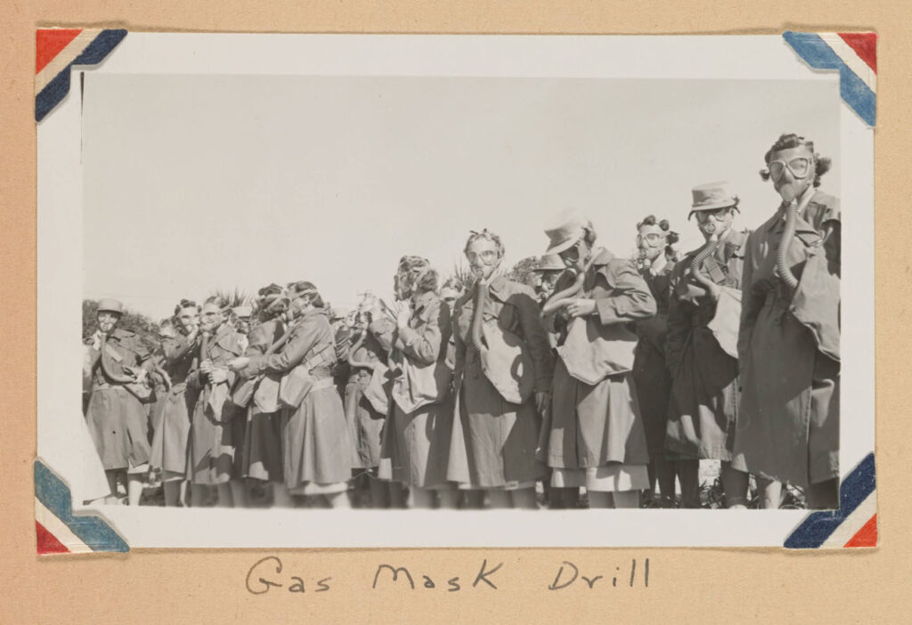 women wearing gas masks during WWII military training drill