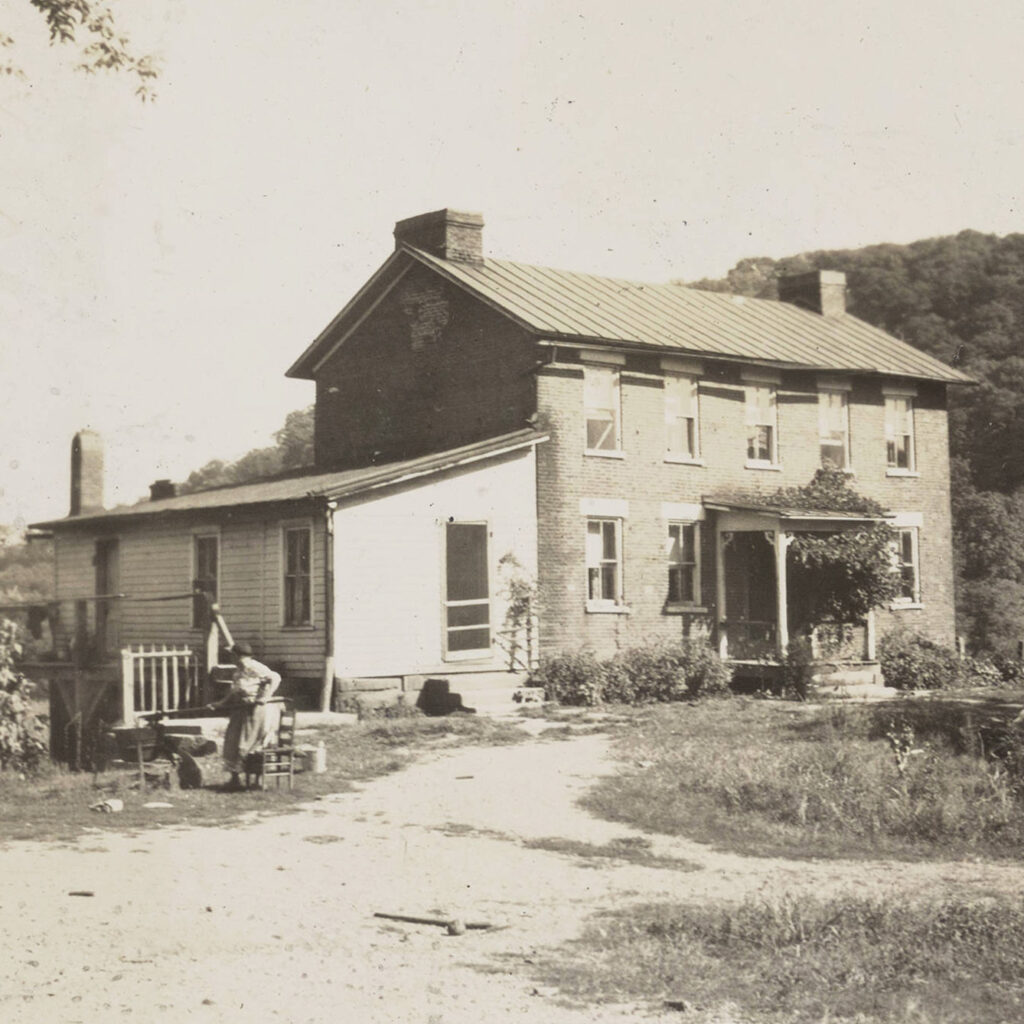 The Rowell House photographed in 1939 with a figure standing out in the yard.