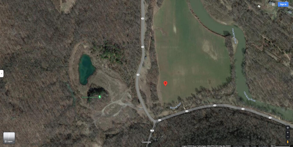 An aerial view with satellite imagery of the area near where the Rowell House was located. The possible location is marked with a red pin in the middle of a field.