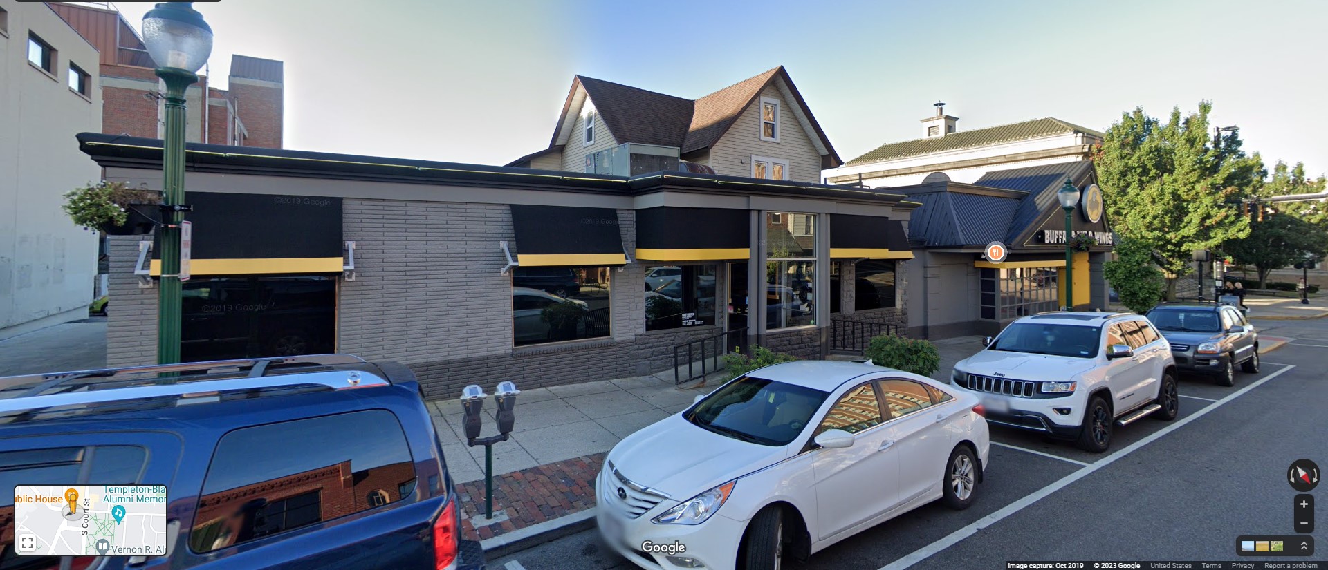 Google Street View image of Buffalo Wild Wings restaurant on street with cars parked