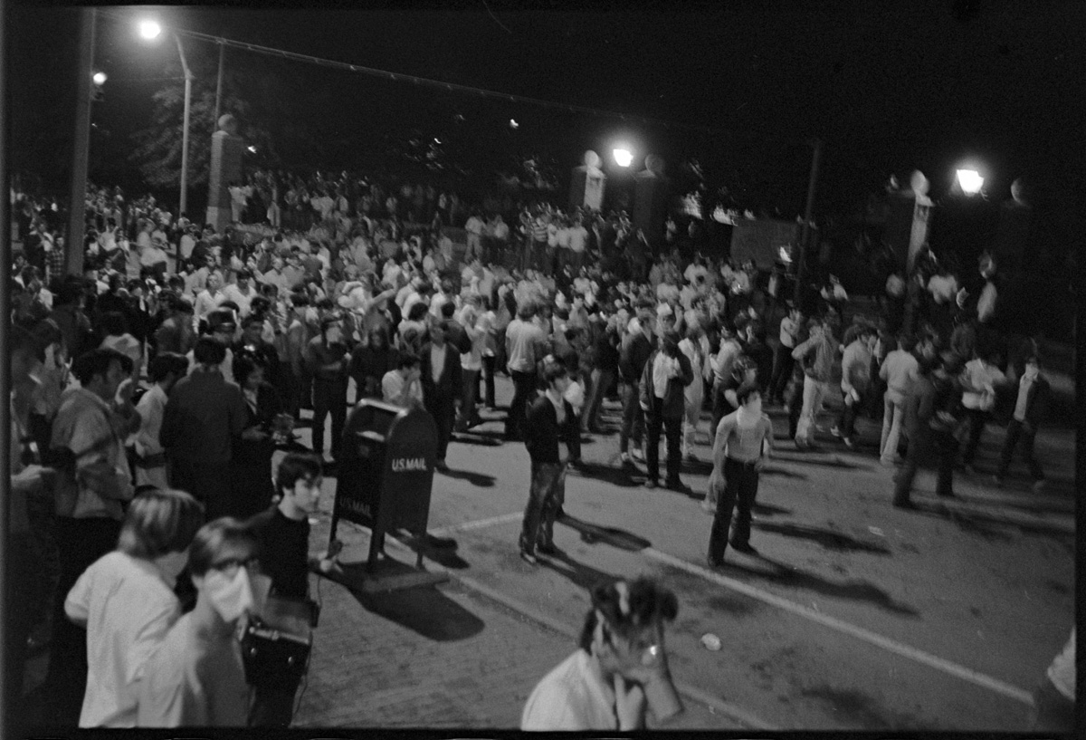 Large crowd of students at night gathered in the street near Ohio University Class Gateway