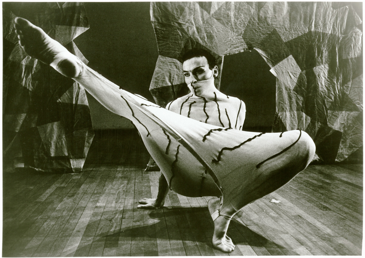 Murray Louis in costume with his leg extended during a dance performance of "Chimera"