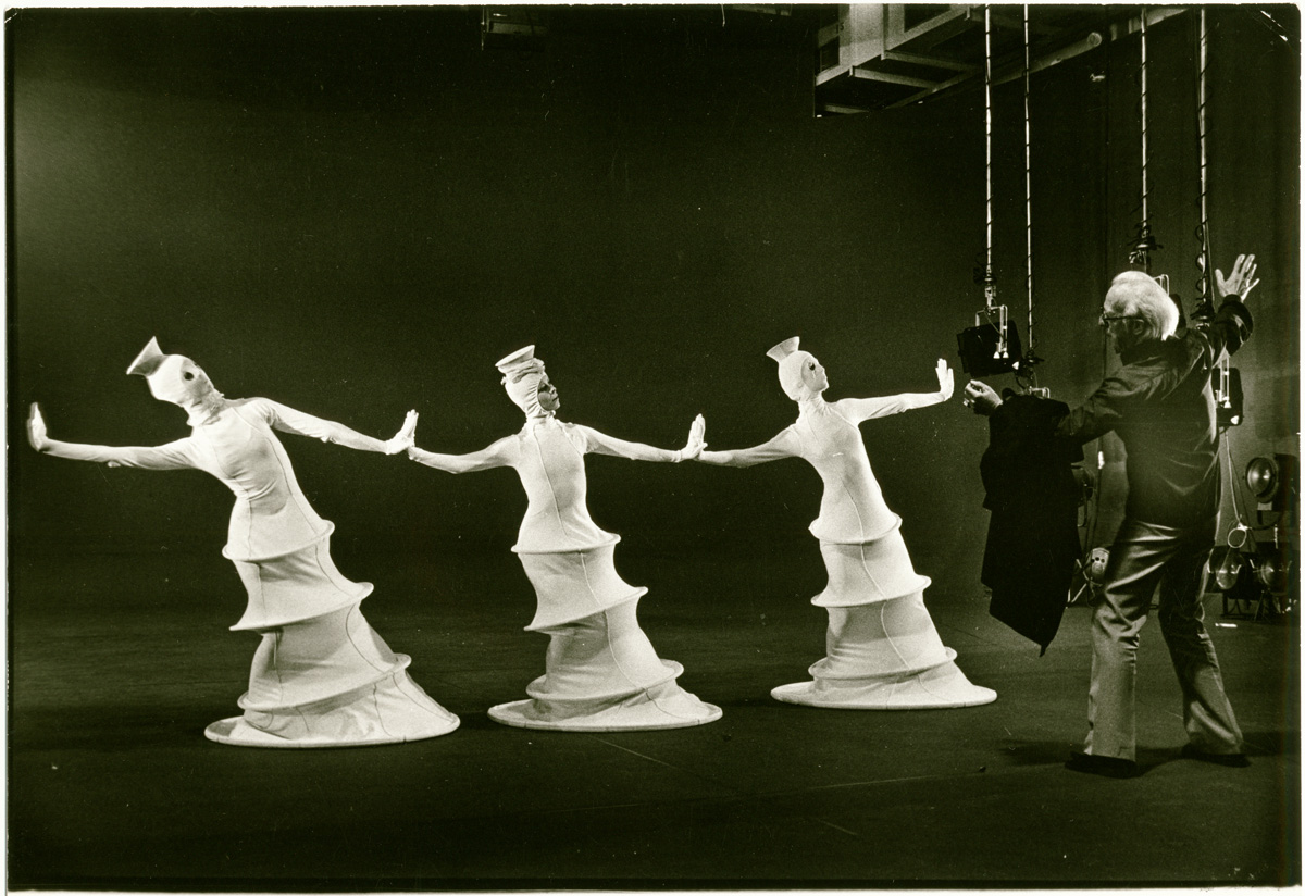 Three dancers in costumes during a rehearsal for Chrysalis under the direction of Alwin Nikolais