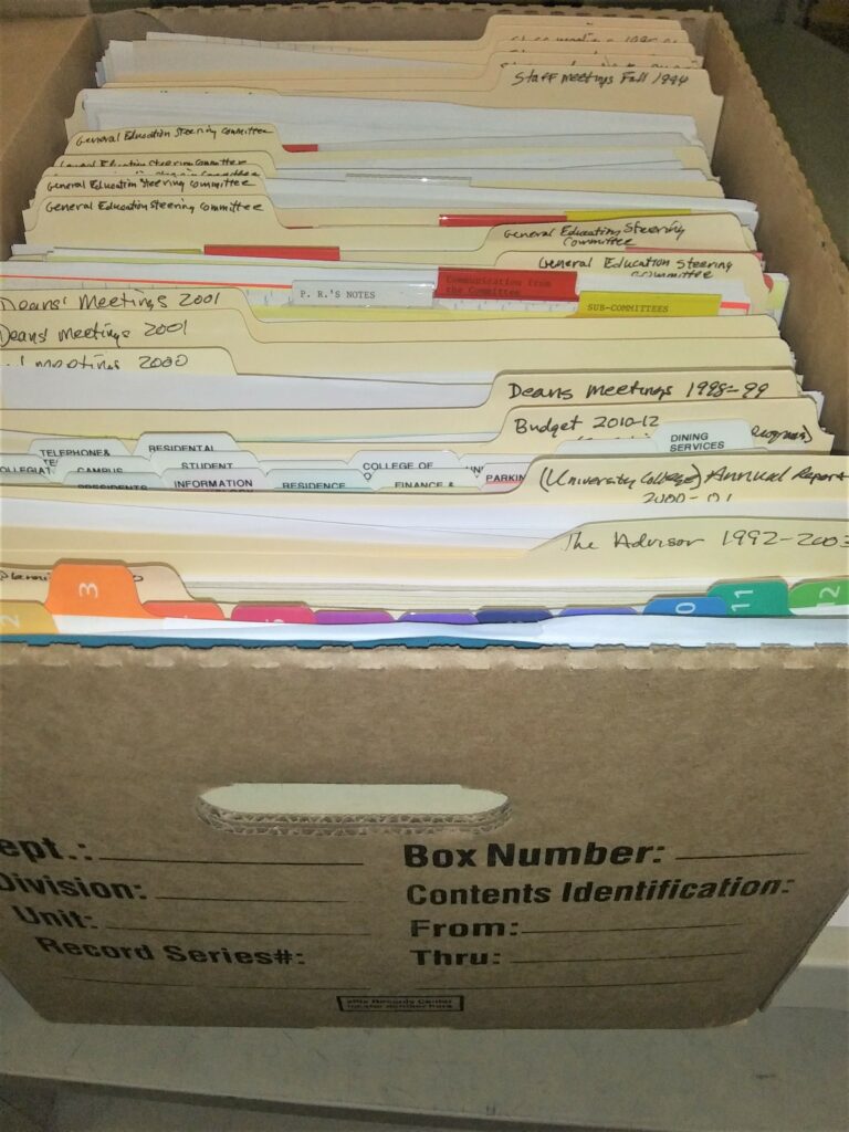 open bankers box filled with folders