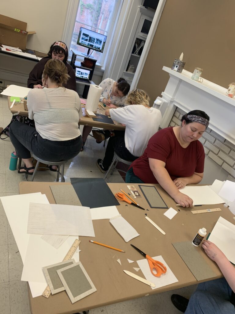 Students making accordion structure artists' books in Sauda Mitchell's workshop