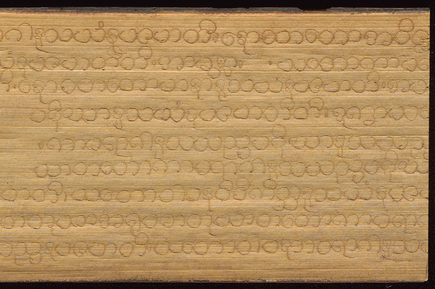 Detailed view of Pali text inscribed on palm leaf manuscript