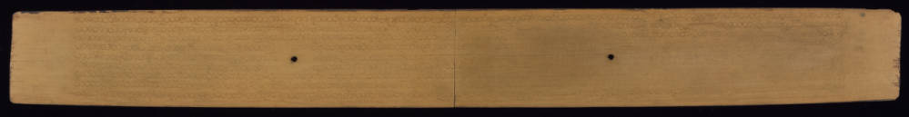 Back side of palm leaf manuscript with inscribed text