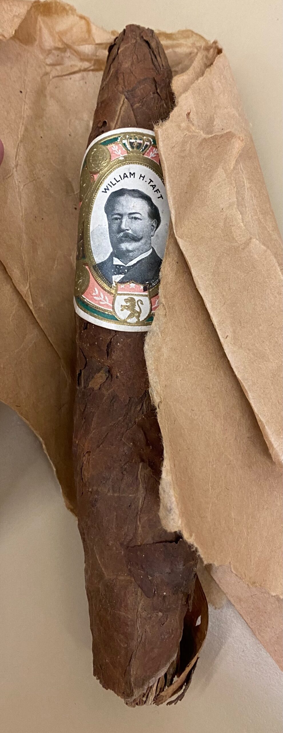 Cigar with photo portrait of Taft wrapped around the center of the cigar.