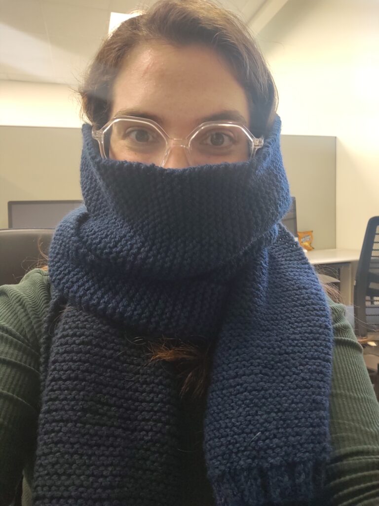 Jessica wearing the scarf she knitted