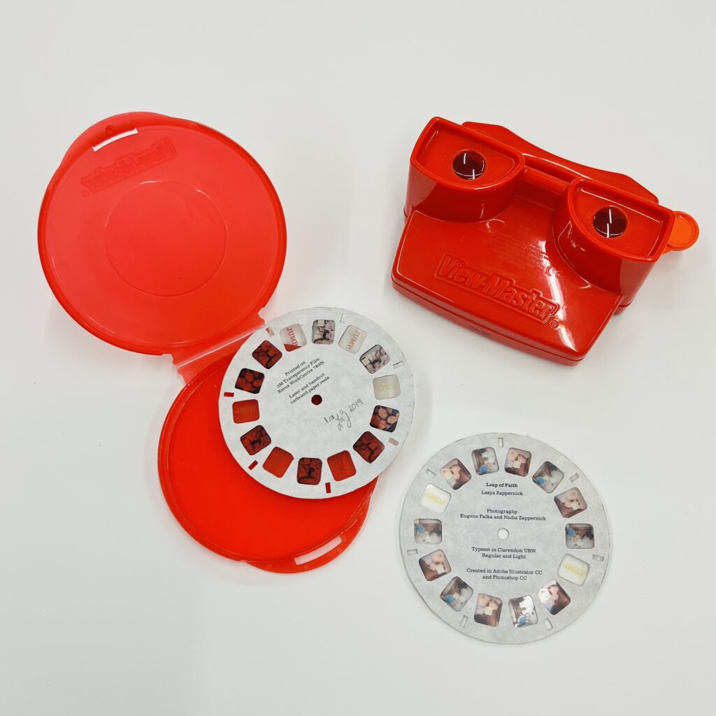 Leap of Faith by Lesya Zappernick. Created in 2019 for Letterpress & Bookmaking with instructor Don Adleta. Red Plastic ViewMaster with laser-printed photos and hand-cut cardboard reels. Photographs by Eugene Palka and Nadia Zappernick.