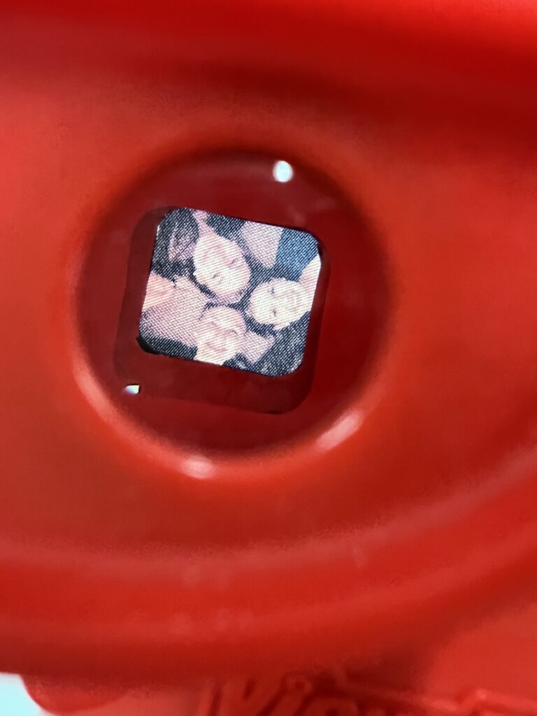 Close up of a photograph from Leap of Faith by Lesya Zappernick. Created in 2019 for Letterpress & Bookmaking with instructor Don Adleta. Red Plastic ViewMaster with laser-printed photos and hand-cut cardboard reels. Photographs by Eugene Palka and Nadia Zappernick.