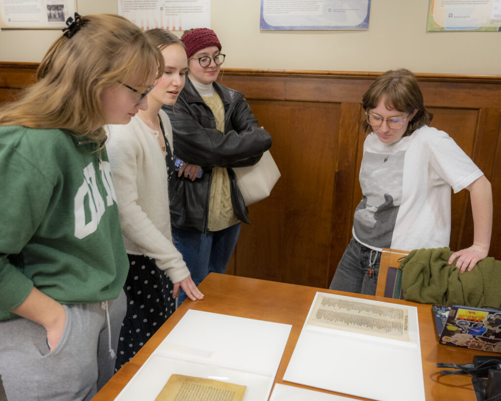 Students and visitors discussing collection materials at the Spring Student Showcase, February 2025.