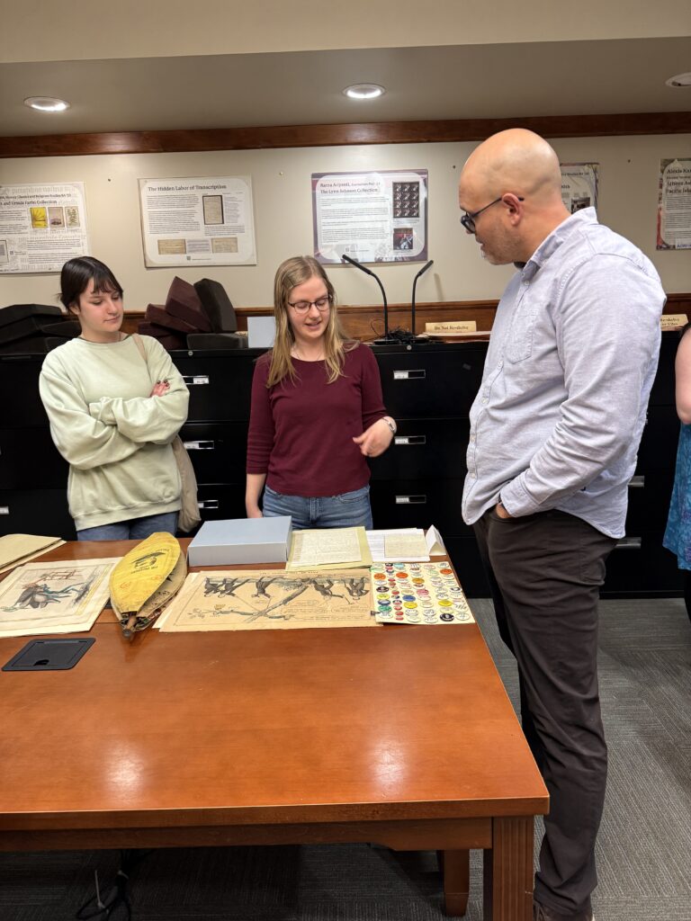 Student employees and interns discuss collection materials with student, faculty, and community visitors during the Showcase.