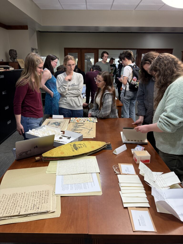 Student employees and interns discuss collection materials with student, faculty, and community visitors during the Showcase.
