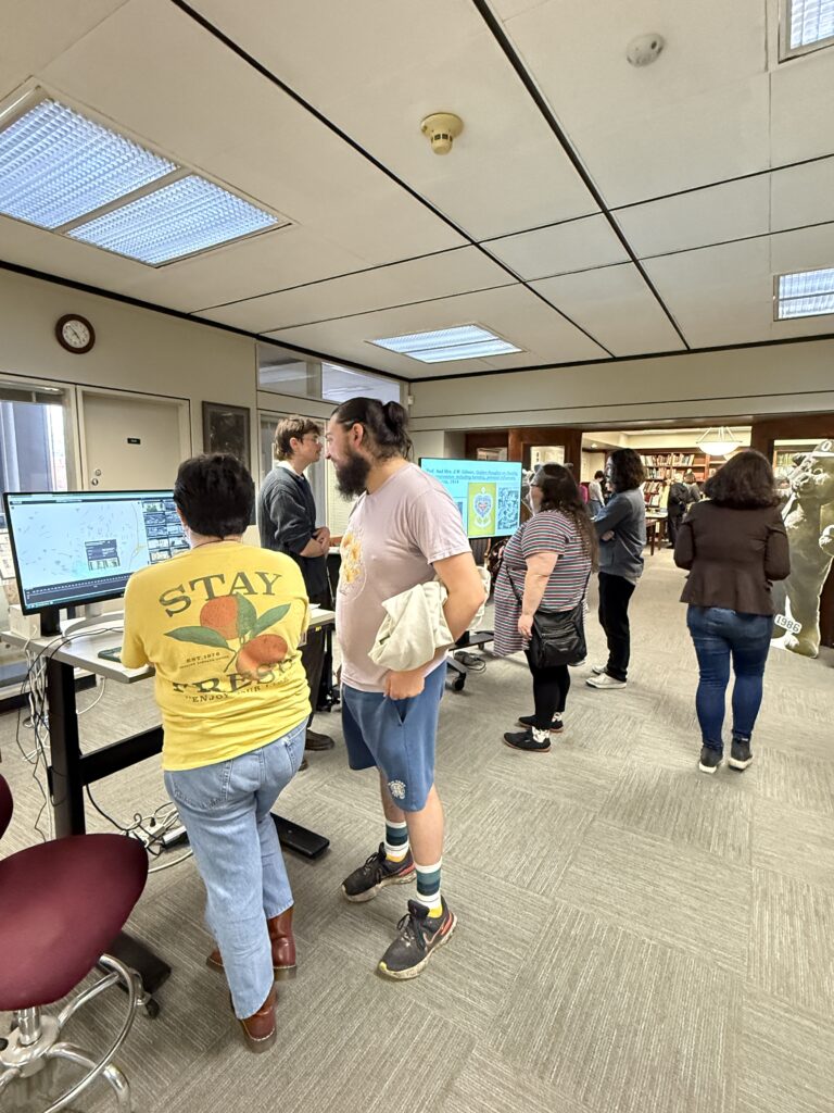 Student employees and interns discuss collection materials with student, faculty, and community visitors during the Showcase.