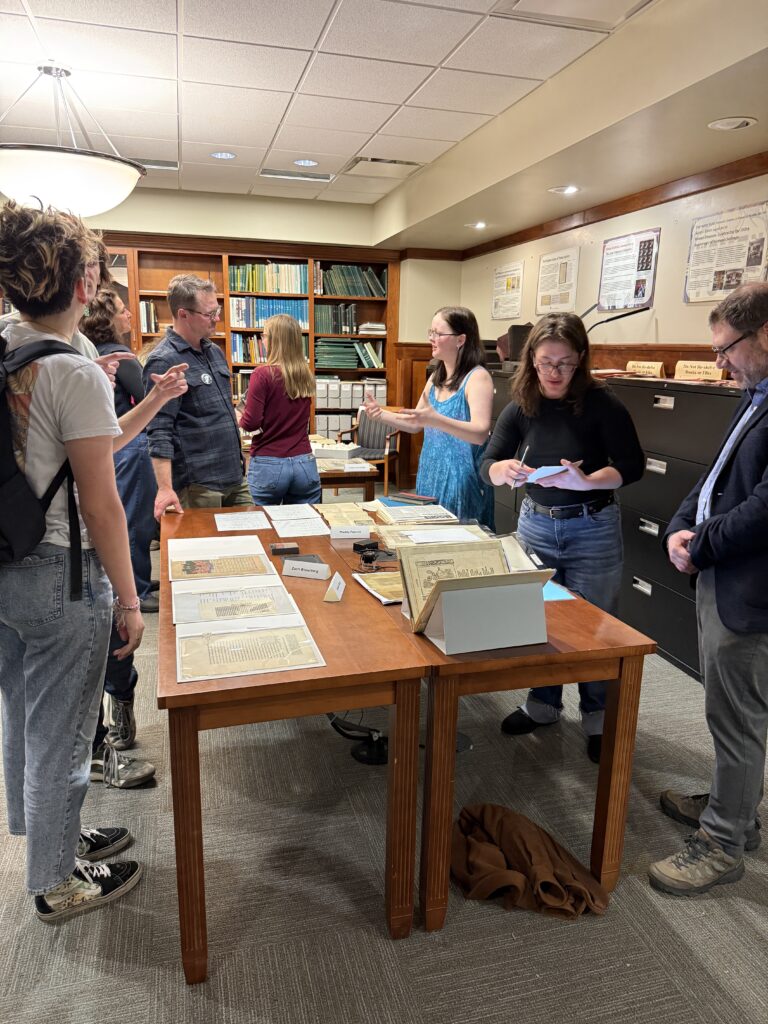 Student employees and interns discuss collection materials with student, faculty, and community visitors during the Showcase.