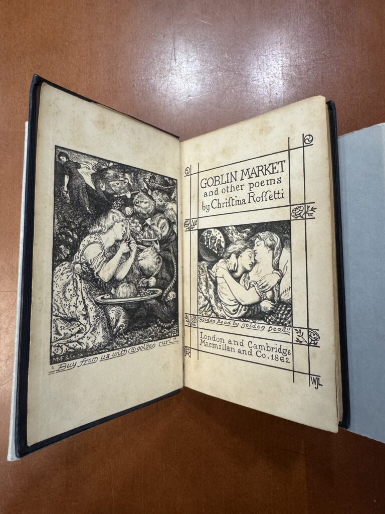 A book lies open in a grey cradle on a brown table. The left-side page features a decorative frontispiece illustration of several woodland creatures and a young girl. It features the text: “Buy from us with a golden curl.” The right-side page features an illustration of two women in an embrace. It features text: “Goblin Market and Other Poems by Christina Rossetti.” Below the illustration text reads: “Golden head by golden head.” Additional text reads: “London and Cambridge. Macmillian and Co. 1862.” 